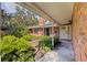 Charming brick home with a covered entryway, complemented by lush landscaping for a welcoming curb appeal at 5901 3Rd S St, St Petersburg, FL 33705