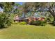 Charming single-story brick home featuring a well-manicured front lawn and mature trees at 5901 3Rd S St, St Petersburg, FL 33705