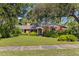 Attractive one-story brick home boasts a lush front yard and mature landscaping at 5901 3Rd S St, St Petersburg, FL 33705