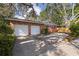 Spacious two-car garage with brick exterior and a large driveway for additional parking at 5901 3Rd S St, St Petersburg, FL 33705