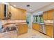 Bright kitchen featuring wood cabinets, granite countertops, stainless steel appliances, and a window overlooking the yard at 5901 3Rd S St, St Petersburg, FL 33705