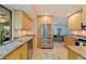 Bright kitchen with stainless steel appliances, light wood cabinets, and granite countertops offers modern functionality at 5901 3Rd S St, St Petersburg, FL 33705