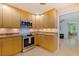 Kitchen features wood cabinets, stainless steel appliances, and access to a dining room at 5901 3Rd S St, St Petersburg, FL 33705