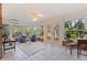 Enclosed Lanai featuring tile floors, brick accents, ceiling fan, and outdoor views at 5901 3Rd S St, St Petersburg, FL 33705