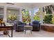 Enclosed sunroom featuring tile flooring, comfortable seating, and natural light at 5901 3Rd S St, St Petersburg, FL 33705