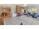 Sunroom with tile floor, brick wall, and views into dining room at 5901 3Rd S St, St Petersburg, FL 33705