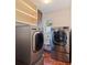 Laundry room equipped with modern washer and dryer, storage shelving, and sink at 5901 3Rd S St, St Petersburg, FL 33705