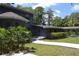 Unique architectural design with mature landscaping enhancing the property's charm at 6160 Fitzgerald Road, Odessa, FL 33556
