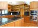 Gourmet kitchen featuring custom wood cabinetry and stainless-steel appliances at 6160 Fitzgerald Road, Odessa, FL 33556