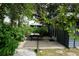 A private patio featuring dining set and lush greenery, perfect for relaxation at 6160 Fitzgerald Road, Odessa, FL 33556