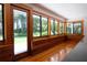 Bright sunroom with beautiful wood floors and large windows overlooking the yard at 6160 Fitzgerald Road, Odessa, FL 33556