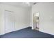 Carpeted bedroom with closet space and a door leading to the bathroom at 6249 Osprey Lake Cir, Riverview, FL 33578