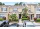 Exterior shot of inviting townhouses featuring covered entries and well-manicured greenery at 6249 Osprey Lake Cir, Riverview, FL 33578