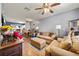 Comfortable living room featuring warm tones, stylish furnishings, and an adjoining dining area at 6249 Osprey Lake Cir, Riverview, FL 33578