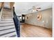 Open living space with wood-look flooring, neutral paint, staircase, and modern ceiling fan at 6249 Osprey Lake Cir, Riverview, FL 33578