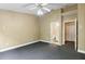 Large carpeted bedroom featuring a ceiling fan, high ceilings and an en-suite bath at 6249 Osprey Lake Cir, Riverview, FL 33578