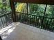Screened outdoor balcony overlooking a green, treed landscape at 647 Fairmont Ave # C, Safety Harbor, FL 34695