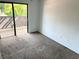 Bright carpeted bedroom with a sliding glass door and balcony access at 647 Fairmont Ave # C, Safety Harbor, FL 34695