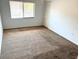 Inviting bedroom with neutral carpeting, window and closet at 647 Fairmont Ave # C, Safety Harbor, FL 34695