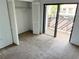 Bedroom featuring a large closet, carpet floors, and balcony access at 647 Fairmont Ave # C, Safety Harbor, FL 34695