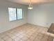 Bright dining area with tile floors, a window, and chandelier at 647 Fairmont Ave # C, Safety Harbor, FL 34695