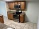 Kitchen featuring stainless steel appliances, granite countertops and tiled flooring at 647 Fairmont Ave # C, Safety Harbor, FL 34695