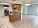 Bright kitchen featuring granite countertops, stainless steel appliances, and tiled floor at 647 Fairmont Ave # C, Safety Harbor, FL 34695