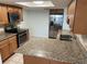 Updated kitchen featuring granite countertops, stainless steel appliances, and tiled backsplash at 647 Fairmont Ave # C, Safety Harbor, FL 34695