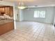 Spacious living room with tile floors seamlessly connected to an open kitchen with granite countertops at 647 Fairmont Ave # C, Safety Harbor, FL 34695