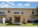 Townhouse backyard with covered patio, grassy area, and air conditioning units at 6954 Hawthorne Trace Ln, Riverview, FL 33578