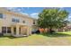 Expansive townhouse backyard features a covered patio, a barbecue grill, and a large tree for shade at 6954 Hawthorne Trace Ln, Riverview, FL 33578
