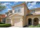 Charming townhome with attached garage and neutral exterior, featuring a welcoming front entrance and well-maintained landscaping at 6954 Hawthorne Trace Ln, Riverview, FL 33578