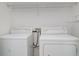 Laundry room featuring a washer, dryer and overhead shelving at 6954 Hawthorne Trace Ln, Riverview, FL 33578