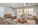 Inviting living room featuring comfortable seating, stylish decor, a ceiling fan, and sliding glass doors to the backyard at 6954 Hawthorne Trace Ln, Riverview, FL 33578