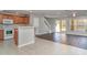 Open-concept living space featuring tile and wood floors, a staircase, and sliding glass doors to the outdoor area at 6954 Hawthorne Trace Ln, Riverview, FL 33578