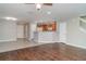 Open-concept living space with tile and wood flooring, flowing into a well-equipped kitchen and a bright dining area at 6954 Hawthorne Trace Ln, Riverview, FL 33578