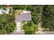 Aerial view showcasing the property's layout, landscaping, and proximity to surrounding trees at 768 Pinellas Point S Dr, St Petersburg, FL 33705