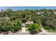 An aerial view of a well-maintained home surrounded by lush landscaping near waterfront at 768 Pinellas Point S Dr, St Petersburg, FL 33705
