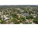 Expansive aerial view of the property nestled among lush greenery and a tranquil lake in a desirable neighborhood at 768 Pinellas Point S Dr, St Petersburg, FL 33705