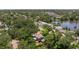 Up-close aerial showcases the property surrounded by mature trees and manicured landscaping, offering serene privacy at 768 Pinellas Point S Dr, St Petersburg, FL 33705