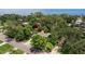 Aerial shot of the home nestled among lush trees in a tranquil, desirable neighborhood at 768 Pinellas Point S Dr, St Petersburg, FL 33705