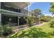 Inviting backyard with a screened porch, verdant lawn, and beautiful greenery at 768 Pinellas Point S Dr, St Petersburg, FL 33705