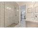 Bright bathroom featuring a glass-enclosed shower with white subway tile and pebble flooring at 768 Pinellas Point S Dr, St Petersburg, FL 33705