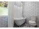 Bathroom featuring a clawfoot tub and shower combination with classic white subway tile at 768 Pinellas Point S Dr, St Petersburg, FL 33705