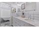 Bright bathroom featuring double vanity, marble countertops, subway tile, and a clawfoot tub/shower at 768 Pinellas Point S Dr, St Petersburg, FL 33705