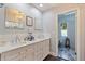 Elegant bathroom featuring a double vanity with marble countertop, decorative mirrors, and access to the shower and bathtub area at 768 Pinellas Point S Dr, St Petersburg, FL 33705