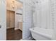 Bathroom featuring a clawfoot tub, subway tile walls, and an open doorway to a double vanity with a marble countertop at 768 Pinellas Point S Dr, St Petersburg, FL 33705