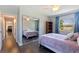 Bedroom with mirrored closet, natural light, and doorway to the hallway at 768 Pinellas Point S Dr, St Petersburg, FL 33705