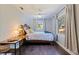 Comfortable bedroom with a wood-framed bed, ceiling fan, and natural light from two windows at 768 Pinellas Point S Dr, St Petersburg, FL 33705