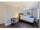 Inviting bedroom with natural light, hardwood flooring, a cozy bed, and a view of the lush surroundings at 768 Pinellas Point S Dr, St Petersburg, FL 33705